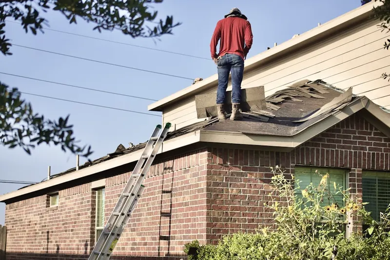 Professional roofer working on a residential roof in Frog Hollow